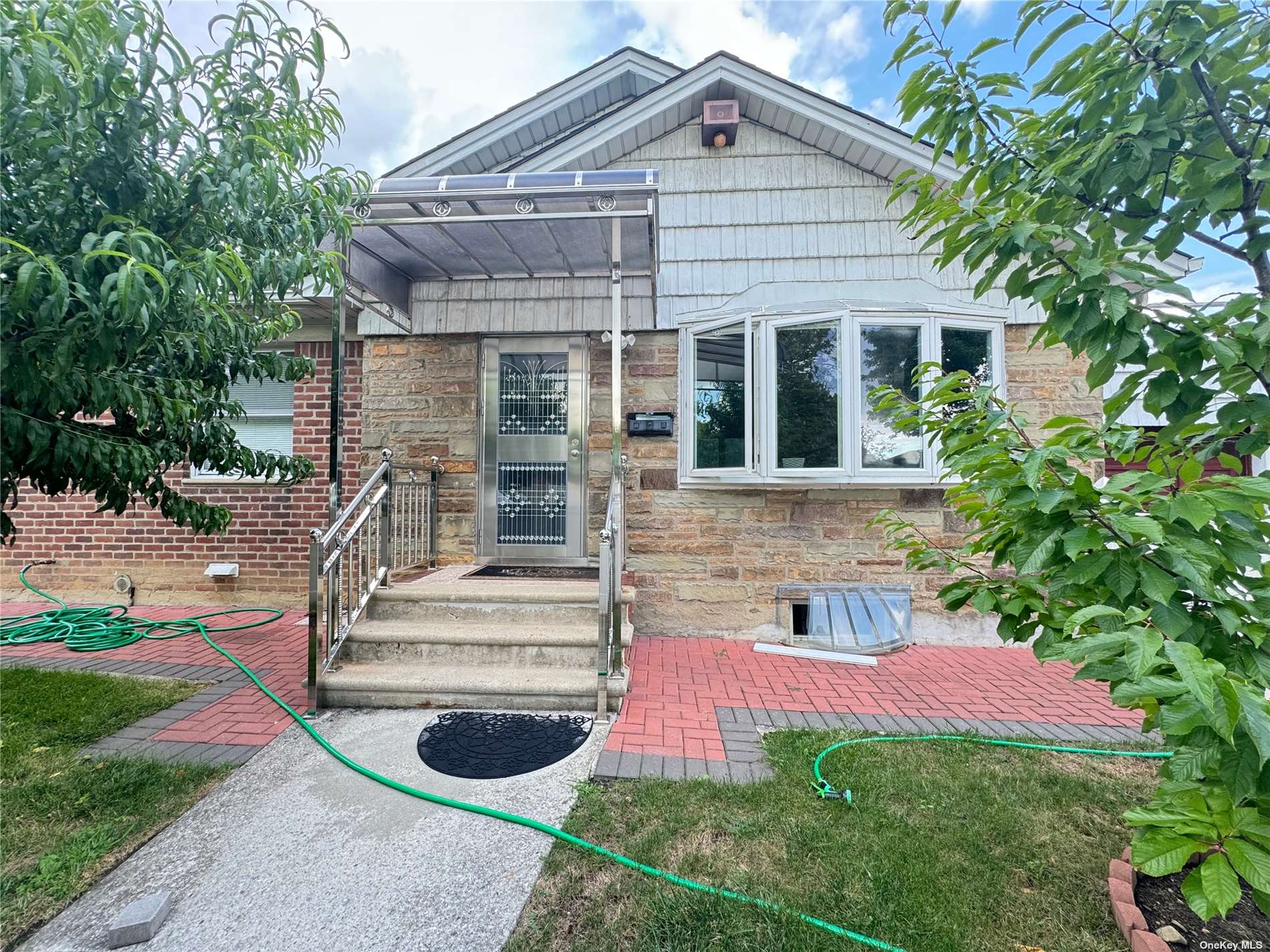 a front view of a house with yard and green space