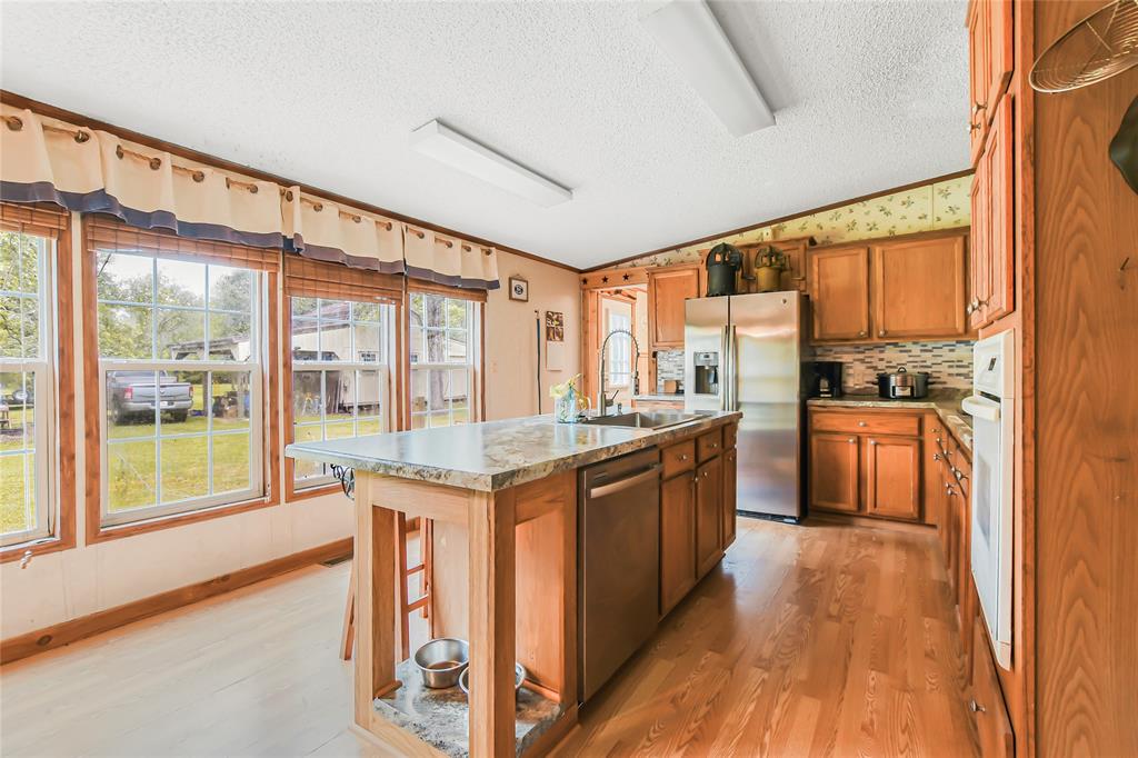Large Kitchen w/ large windows allowing natural light to flow in.