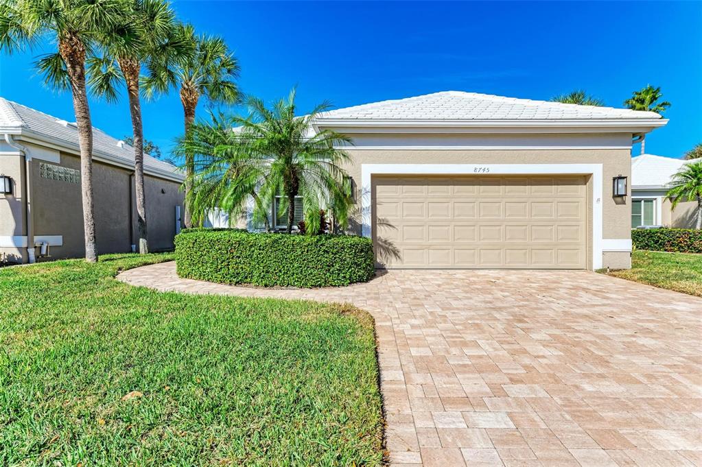 a front view of a house with a yard and garage