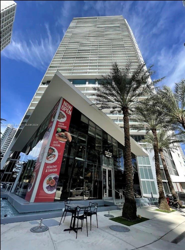 a front view of a building with retail shops