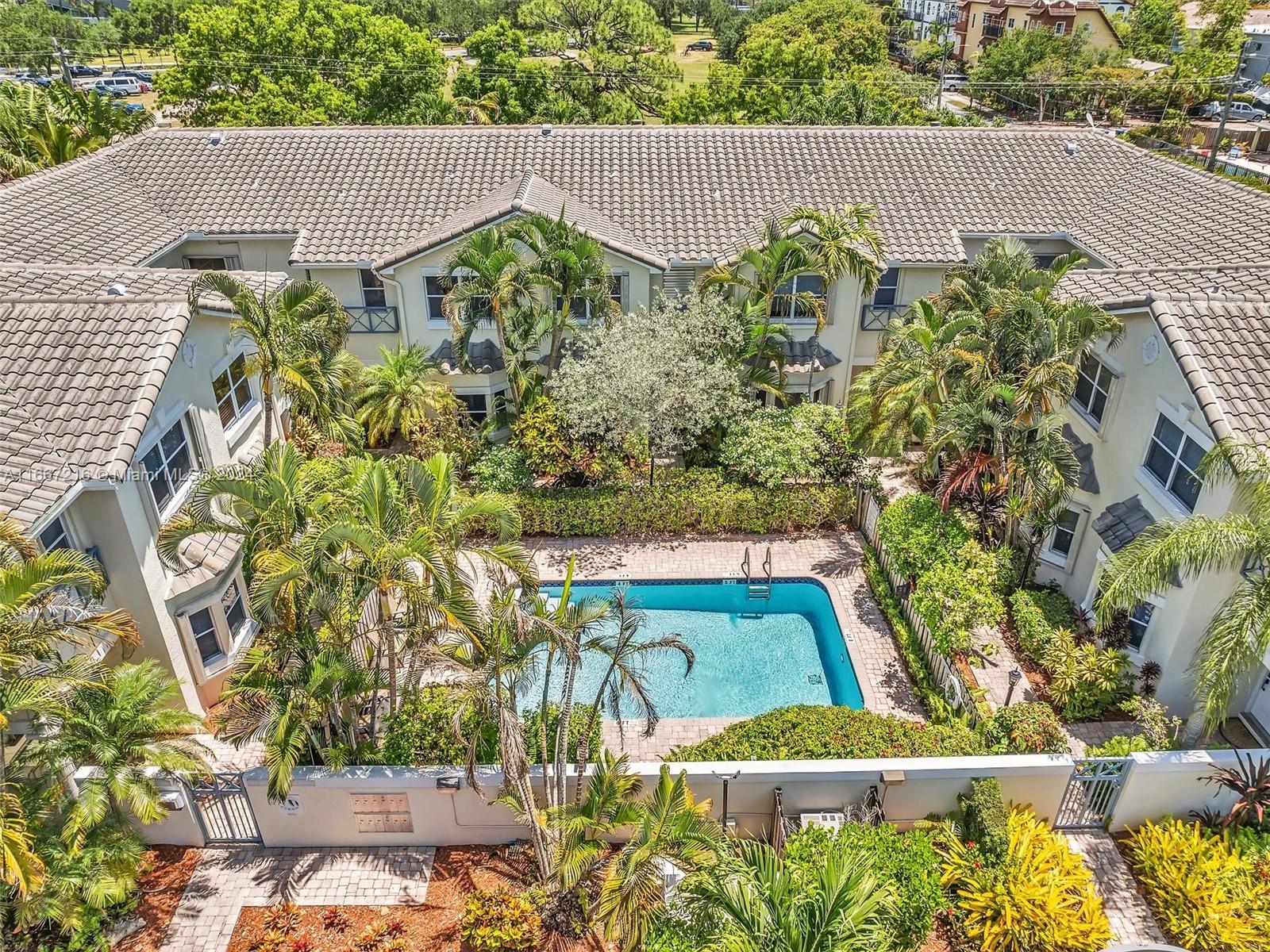 a view of a swimming pool with a flower garden