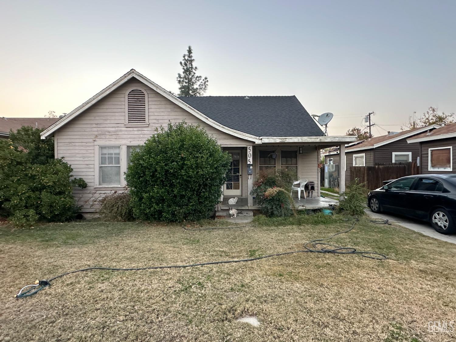 a view of a house with a yard and sitting area