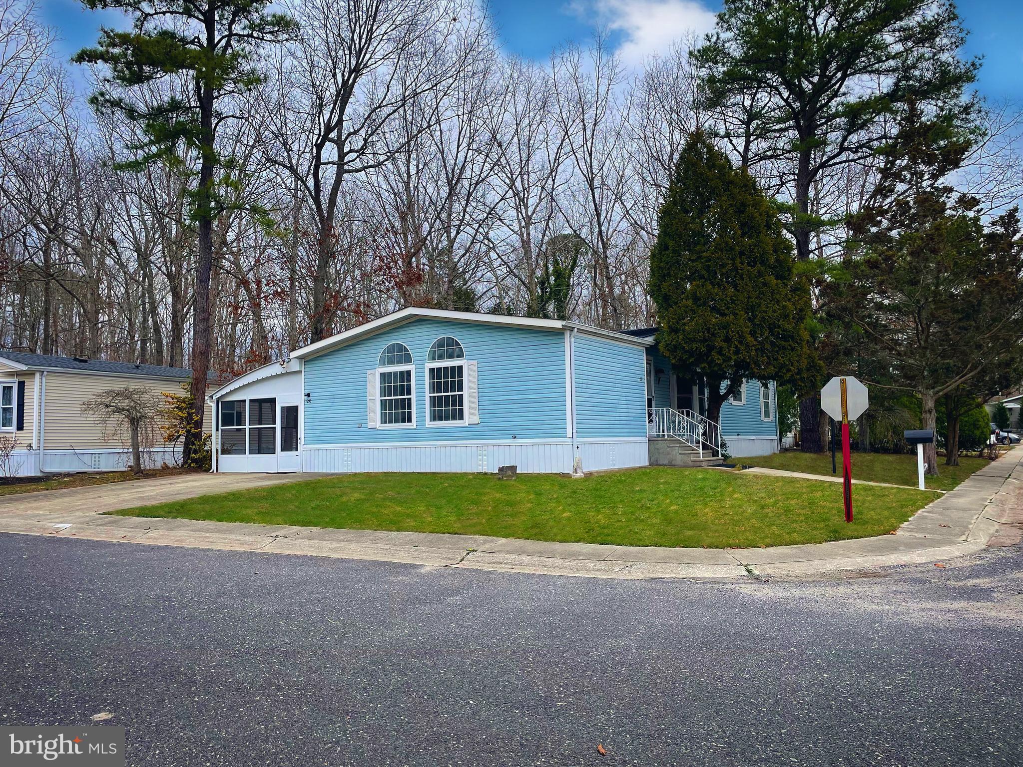 a front view of house with yard and trees