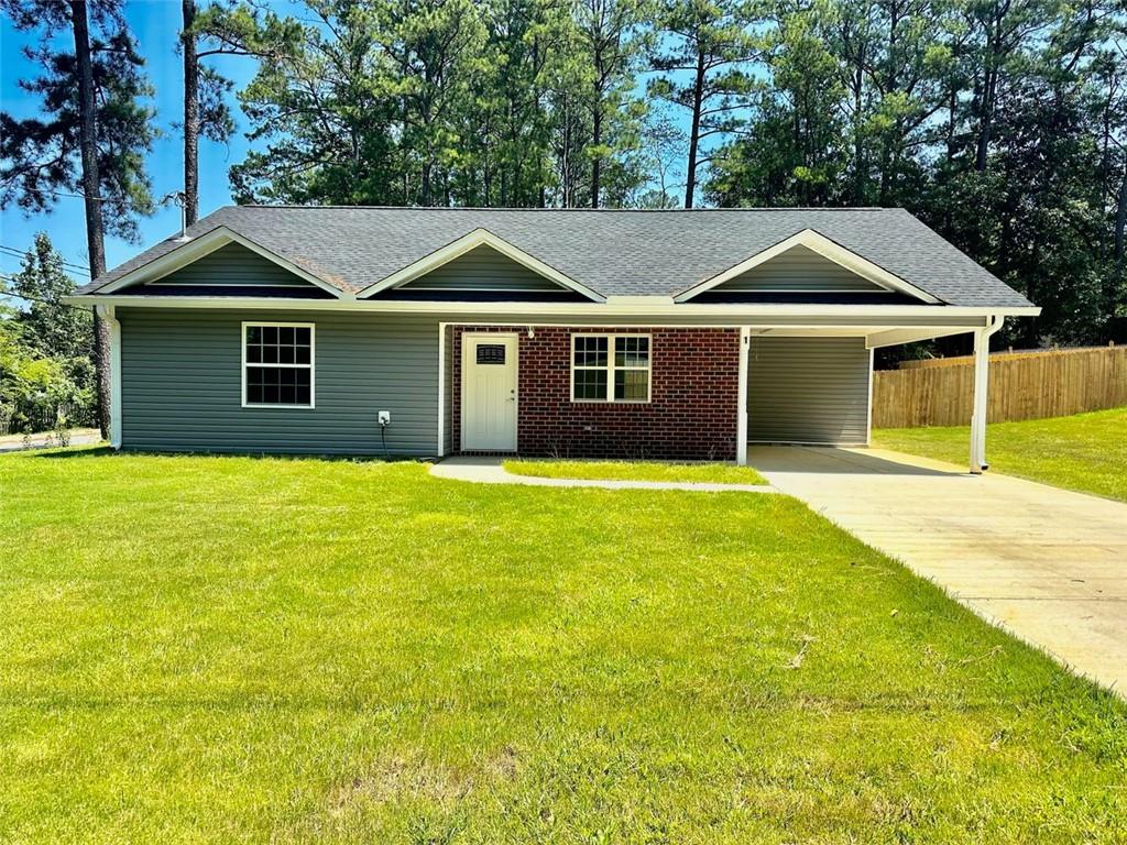 a front view of a house with yard and trees