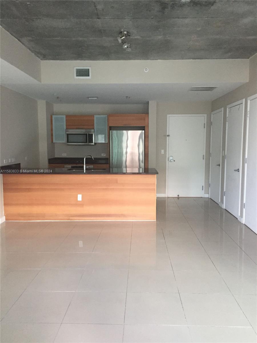 a view of a kitchen with a sink and a dishwasher