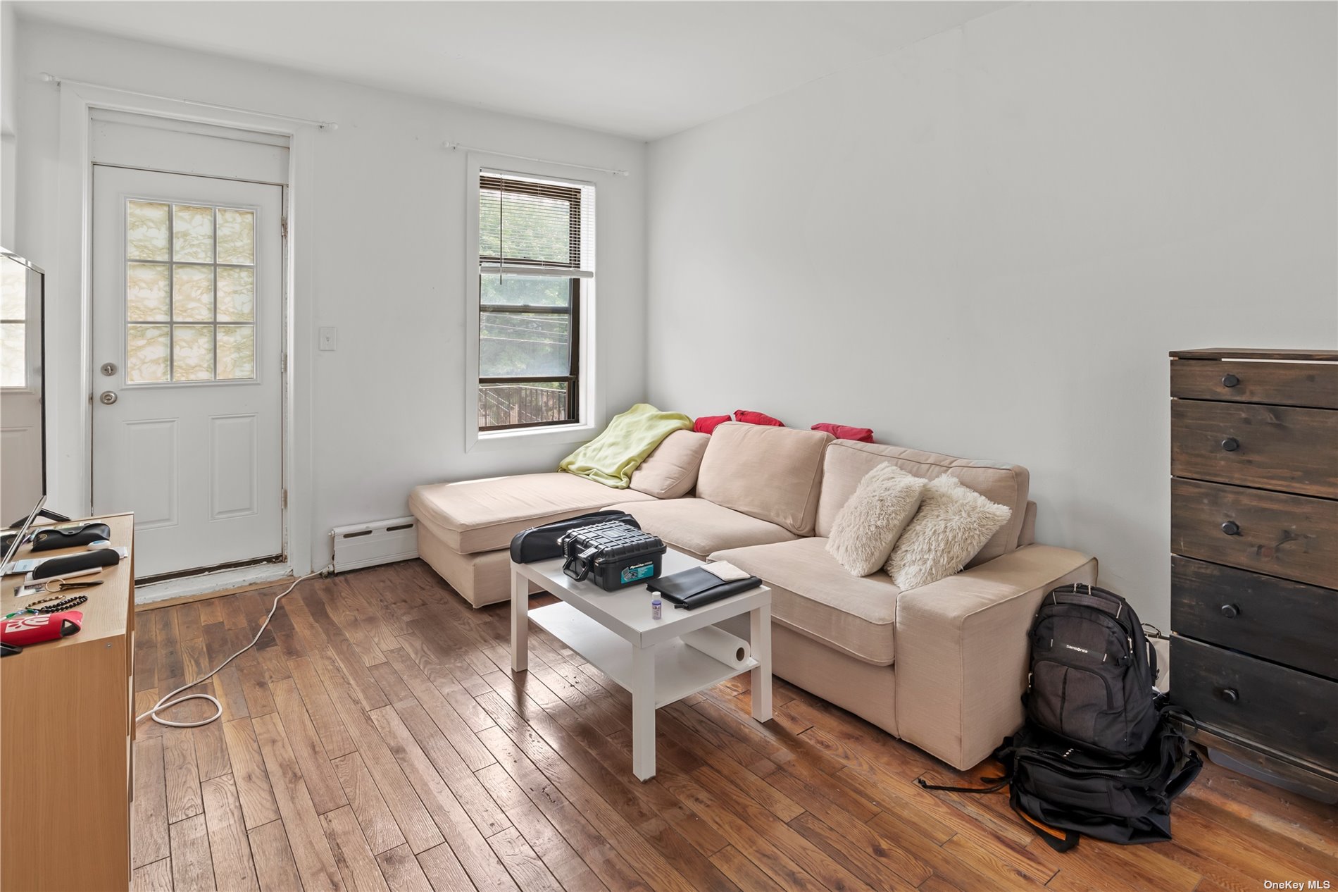 a living room with furniture a couch and a window