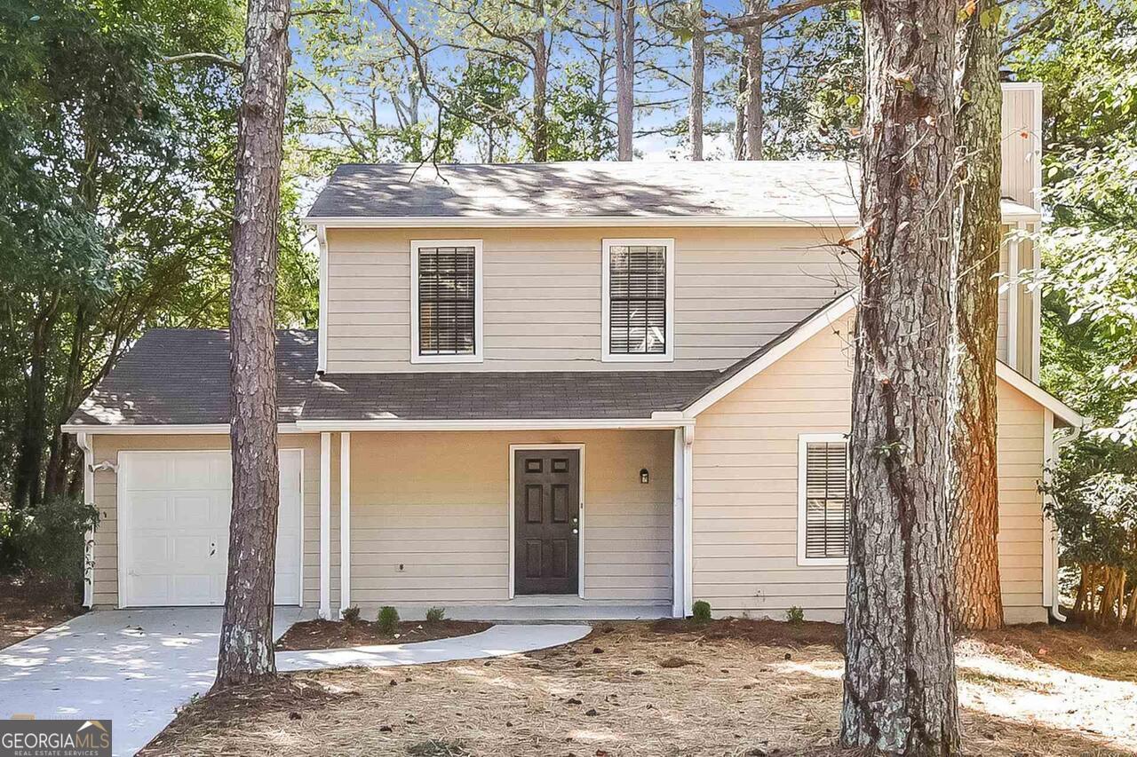 front view of a house with a tree