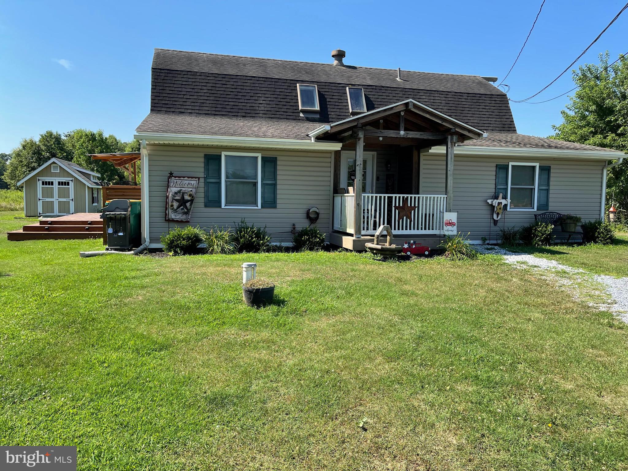 a front view of a house with a yard and porch