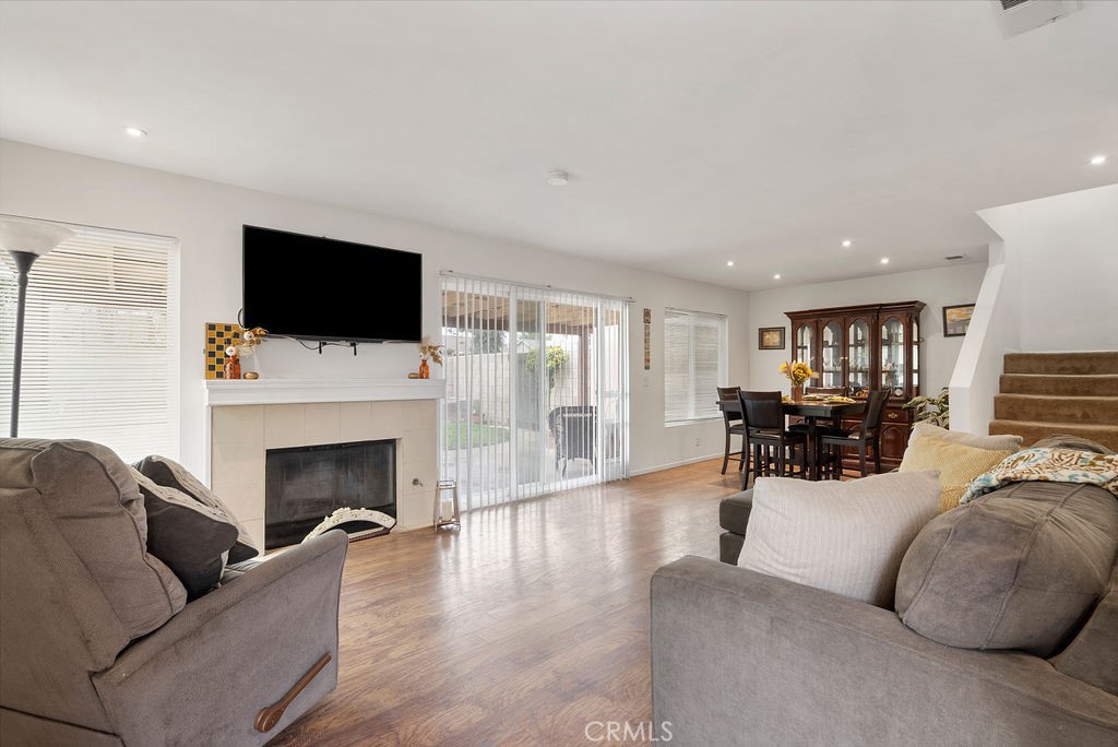 a living room with furniture a flat screen tv and a fireplace