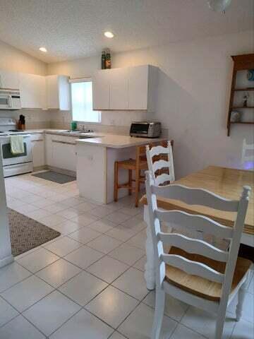 a kitchen with a sink a stove and cabinets