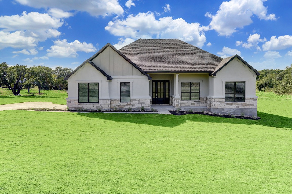 a front view of house with yard and green space