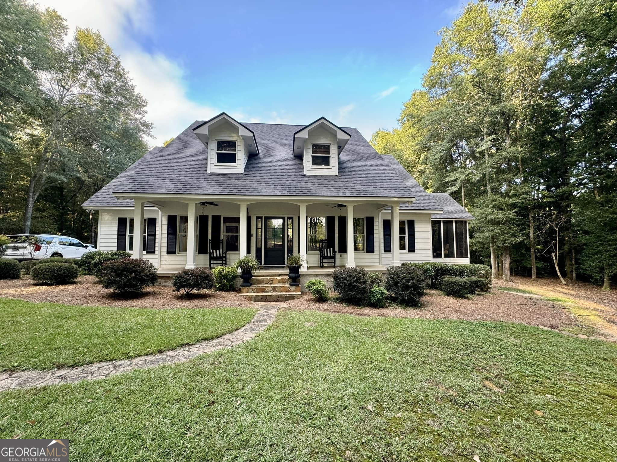 a front view of a house with a yard and porch