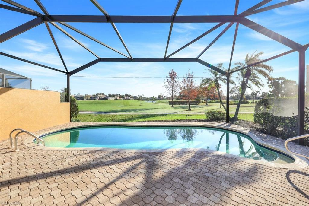 a view of a swimming pool with a yard