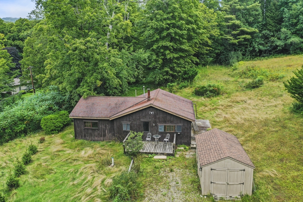 a house with tall trees in the background