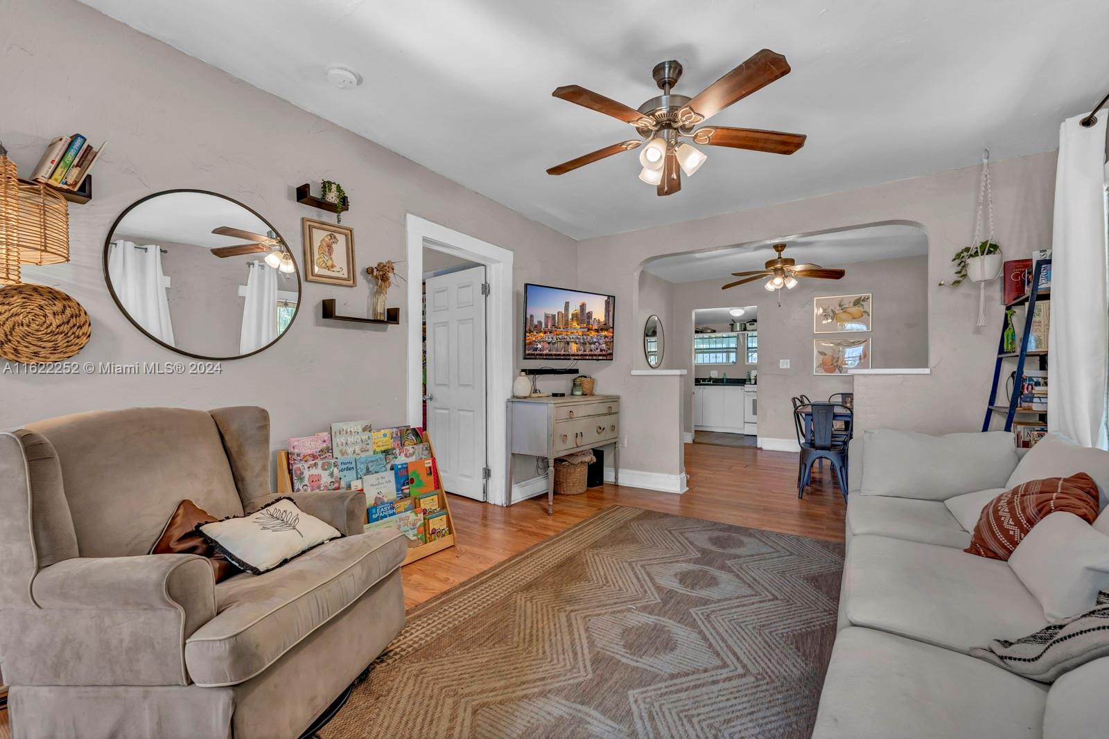 a living room with furniture and wooden floor