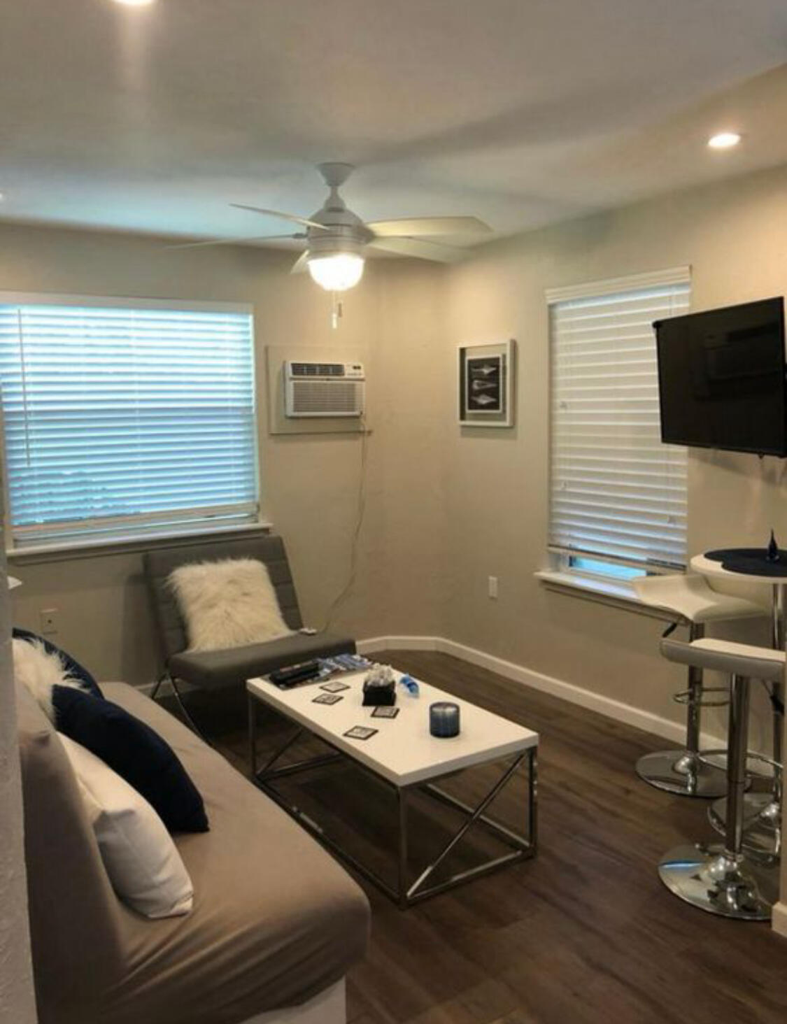 a living room with couches and a flat screen tv