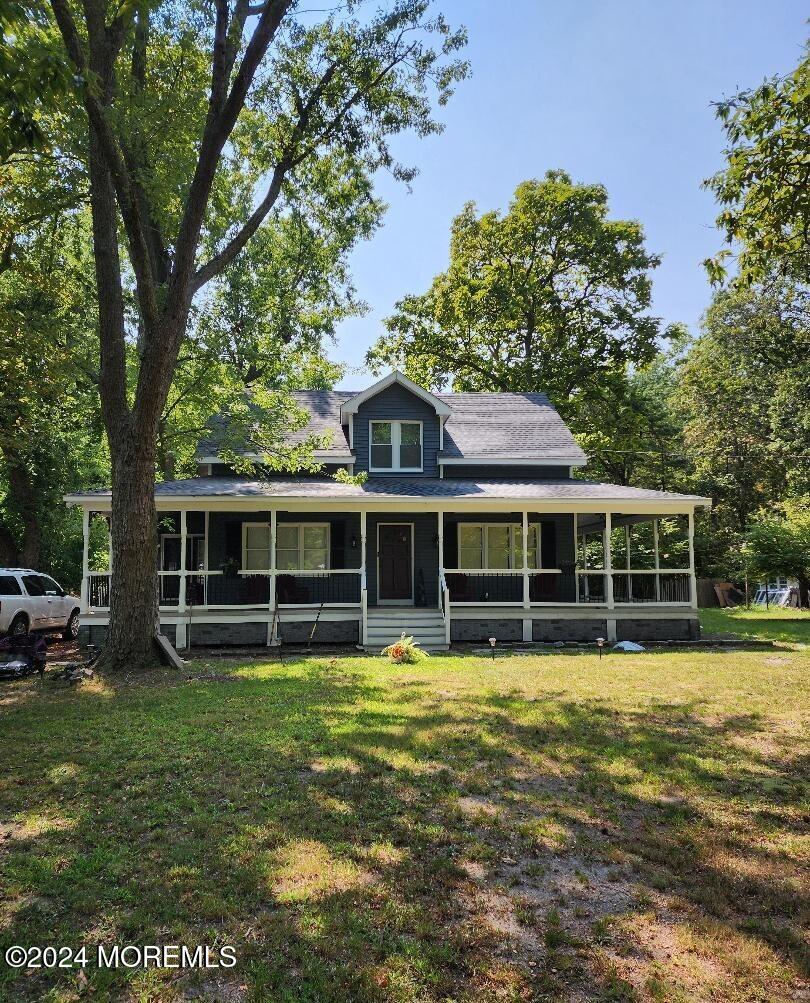 a view of a house with a yard and sitting area