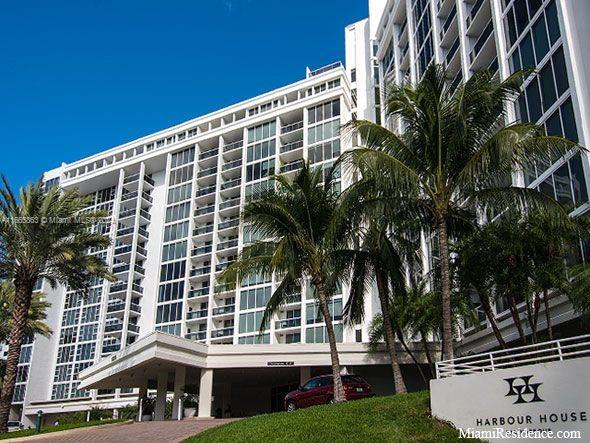 a front view of a building with palm trees