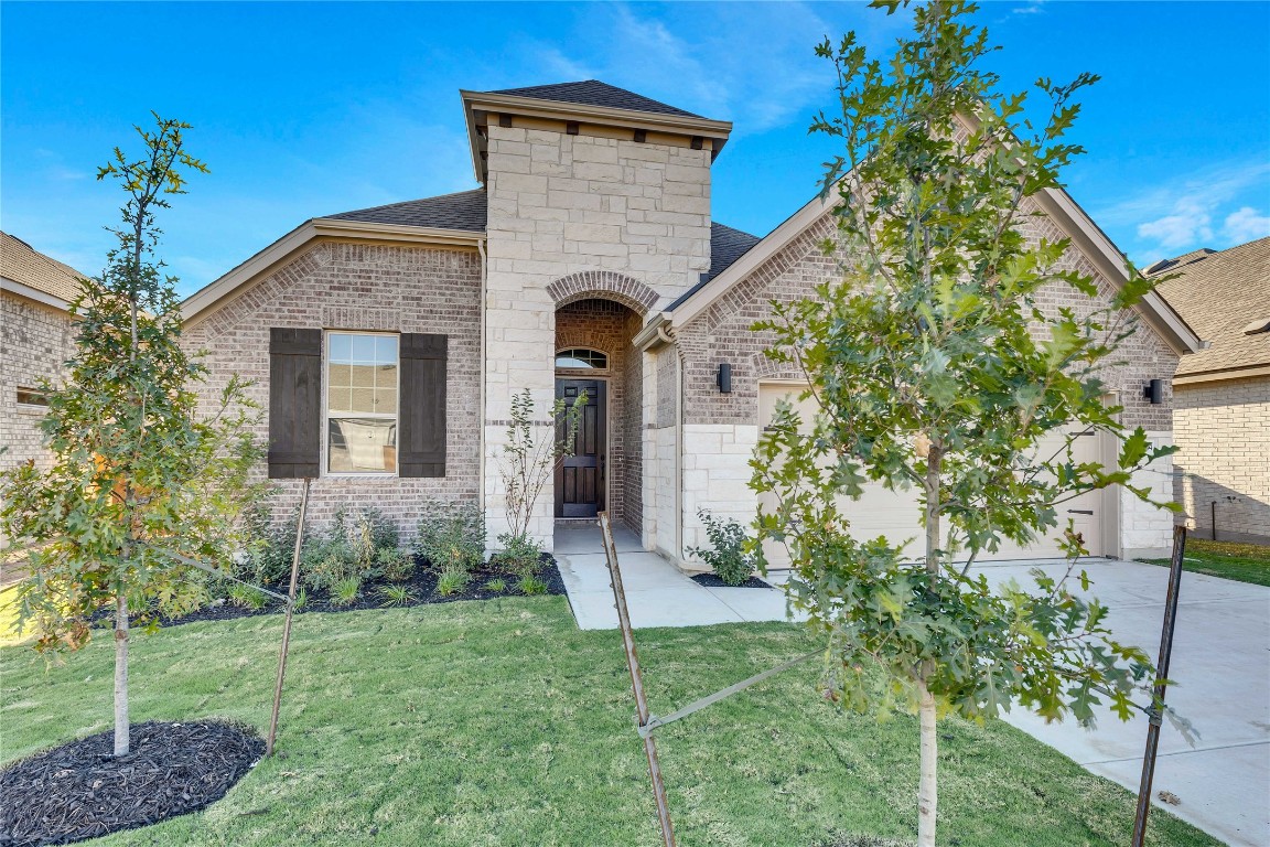 a front view of a house with a yard