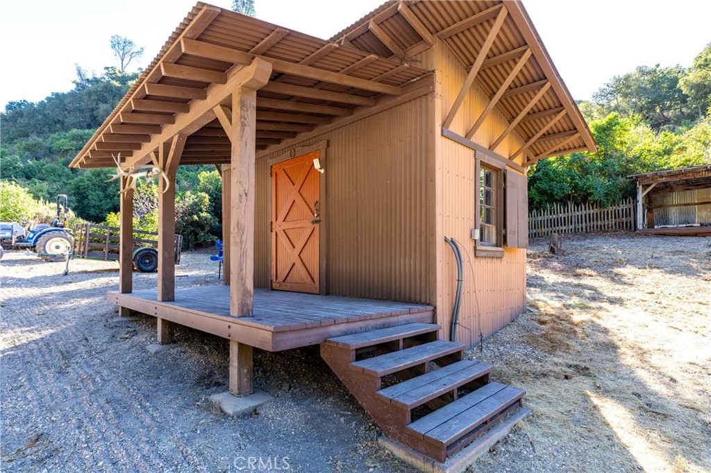 a backyard of a house with table and chairs