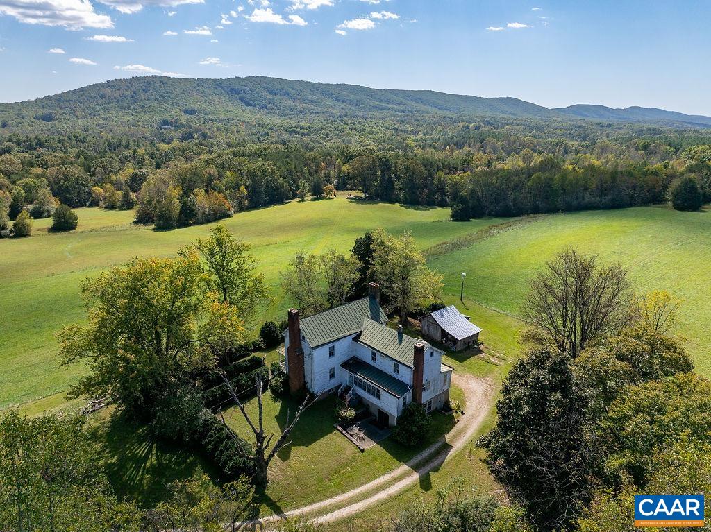 an aerial view of a house with mountain view