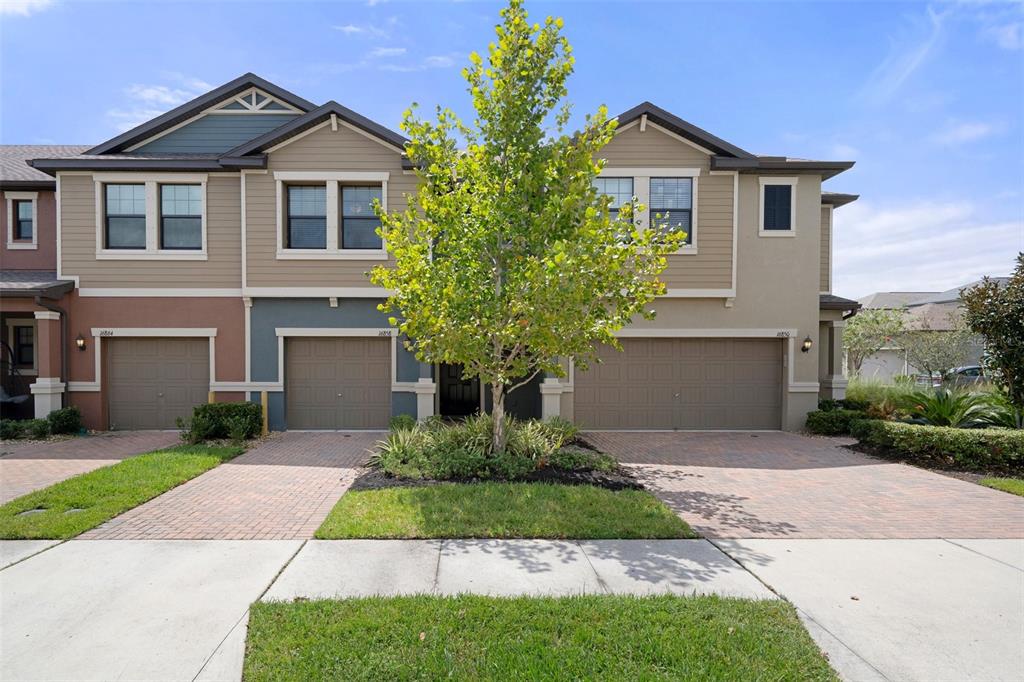 a front view of a house with a yard and garage