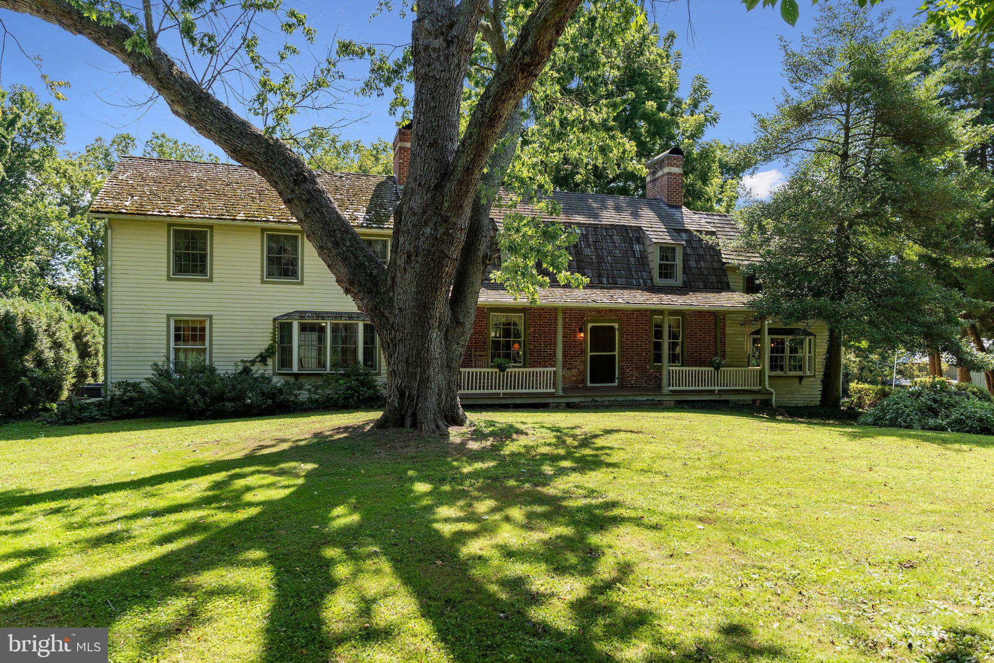 a front view of house with yard and trees