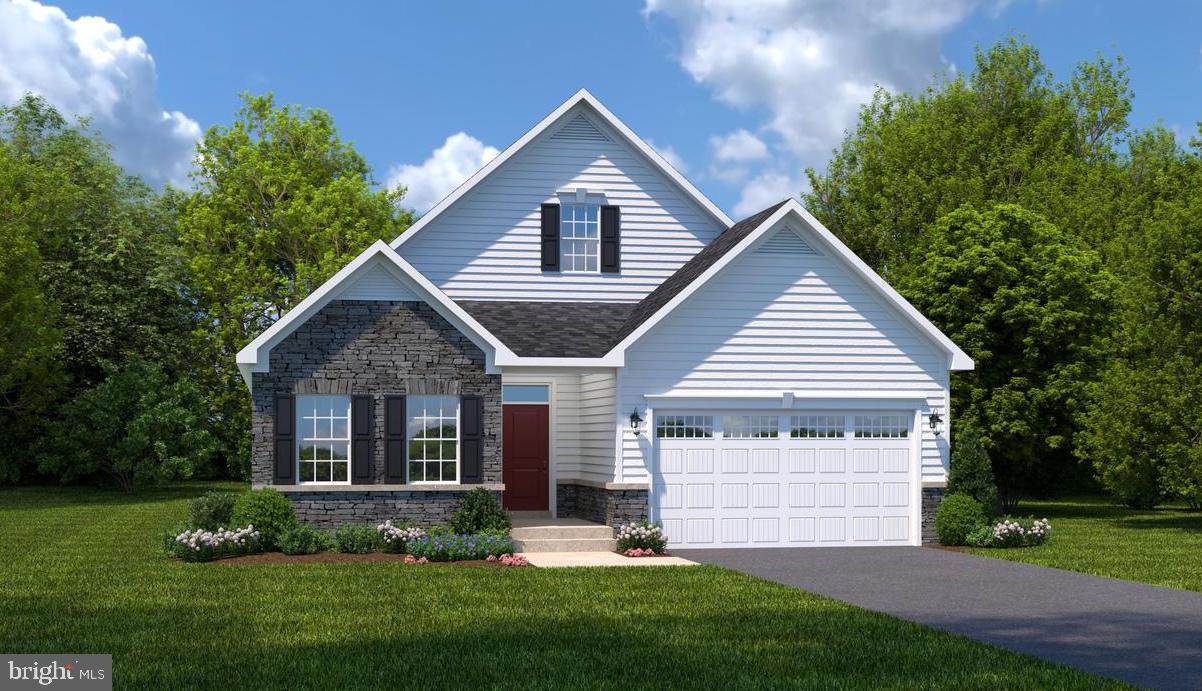 a front view of a house with a garden and yard