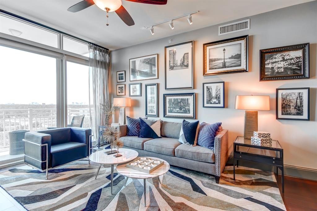 a living room with furniture a table and a large window