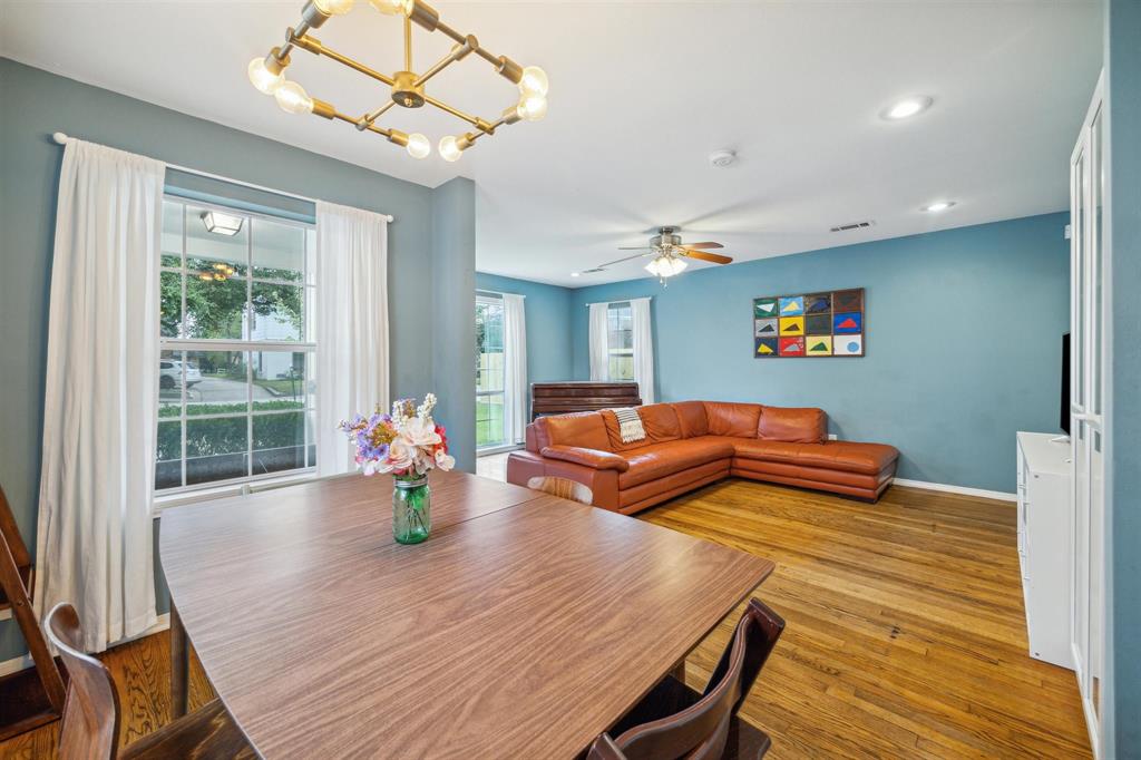 a living room with dining room and wooden floor