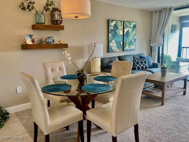 a view of a dining room with furniture and window