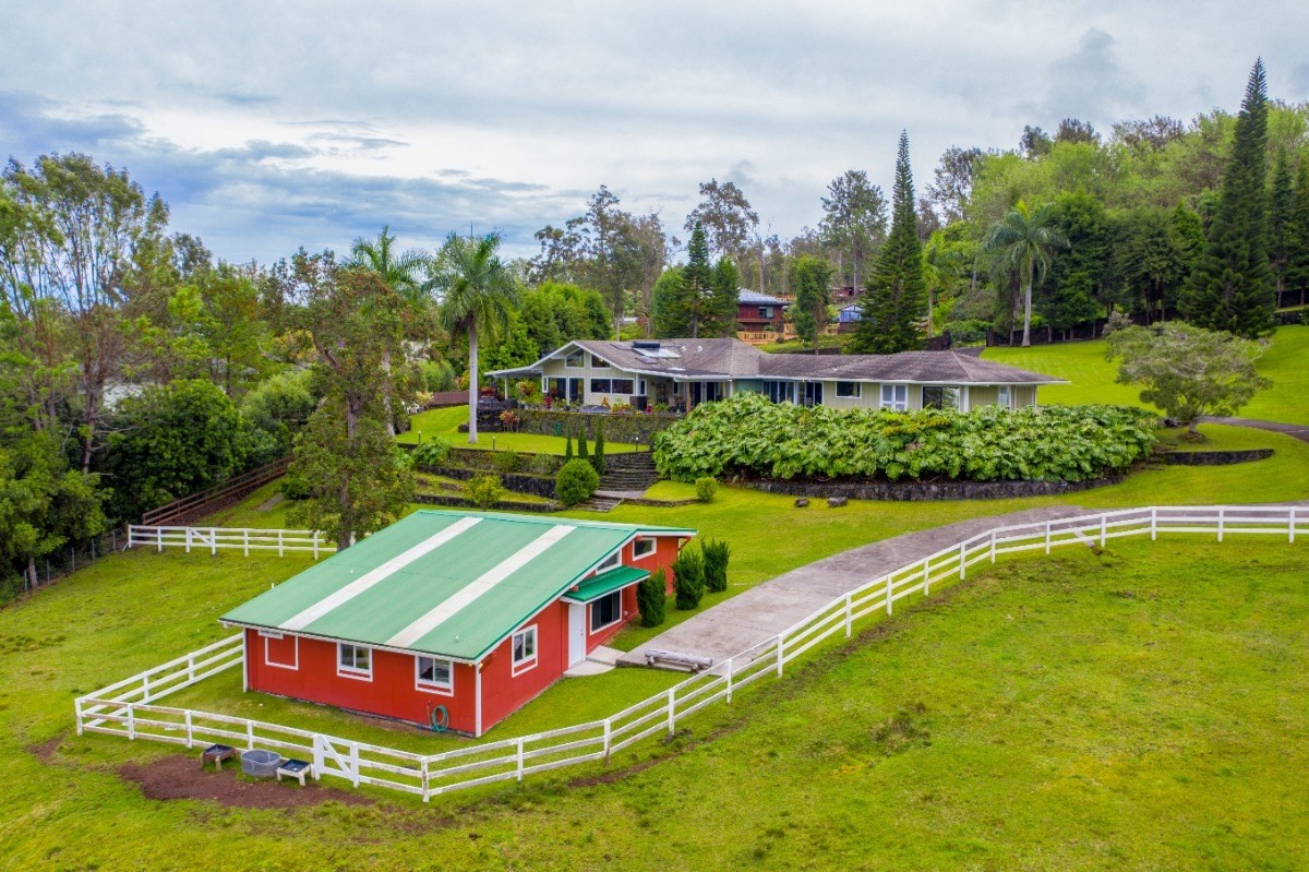 a aerial view of a house with swimming pool yard and outdoor seating