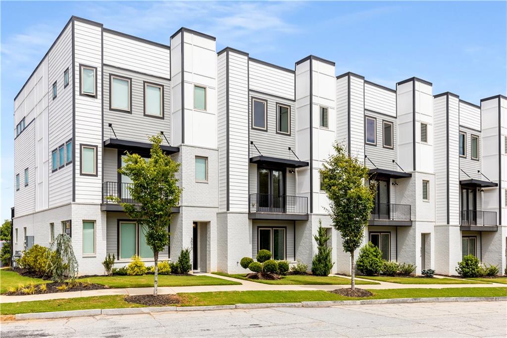 a front view of a residential apartment building with glass windows