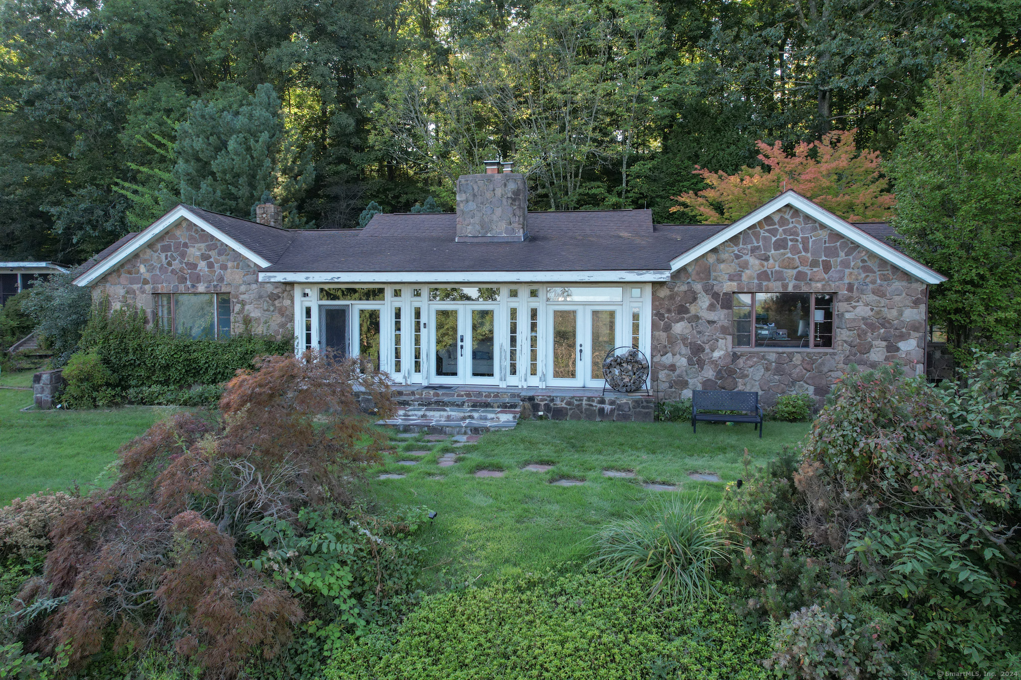 a front view of a house with a garden and yard