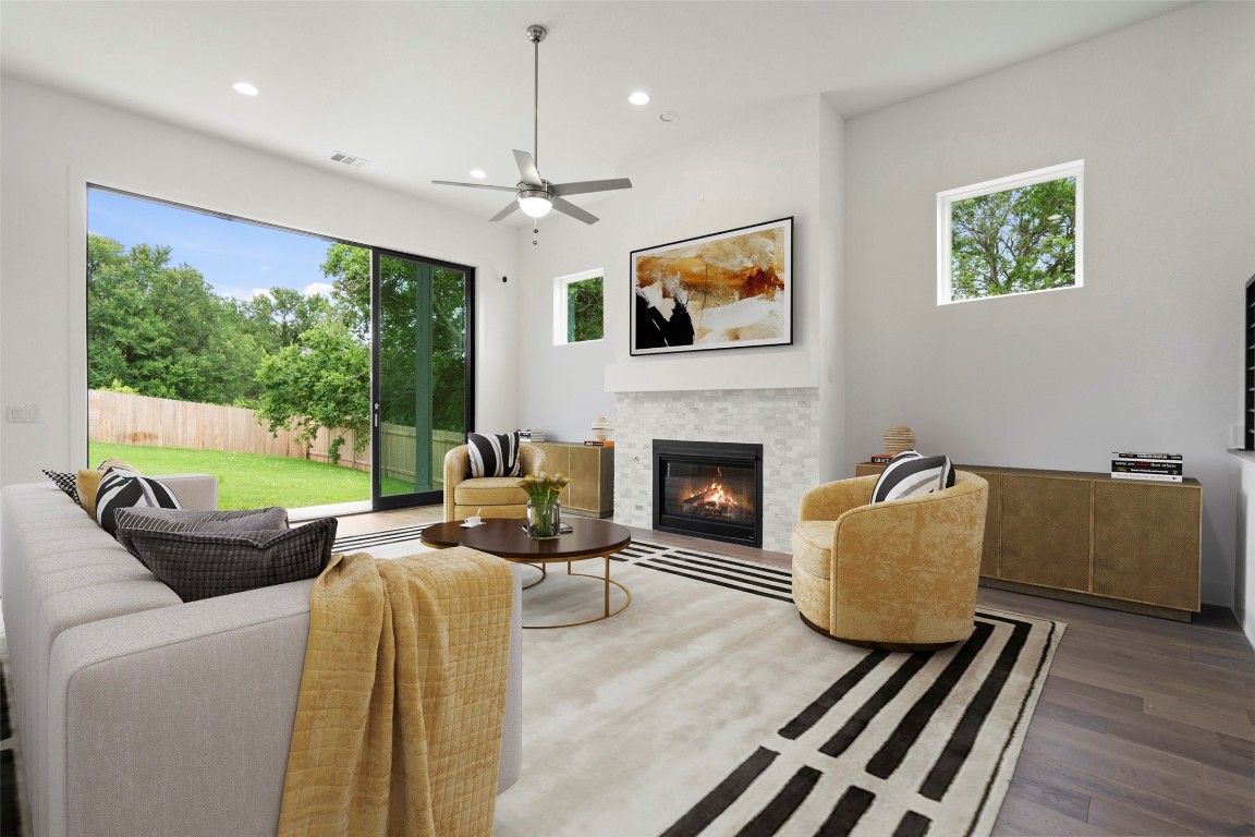 a living room with furniture fireplace and a large window