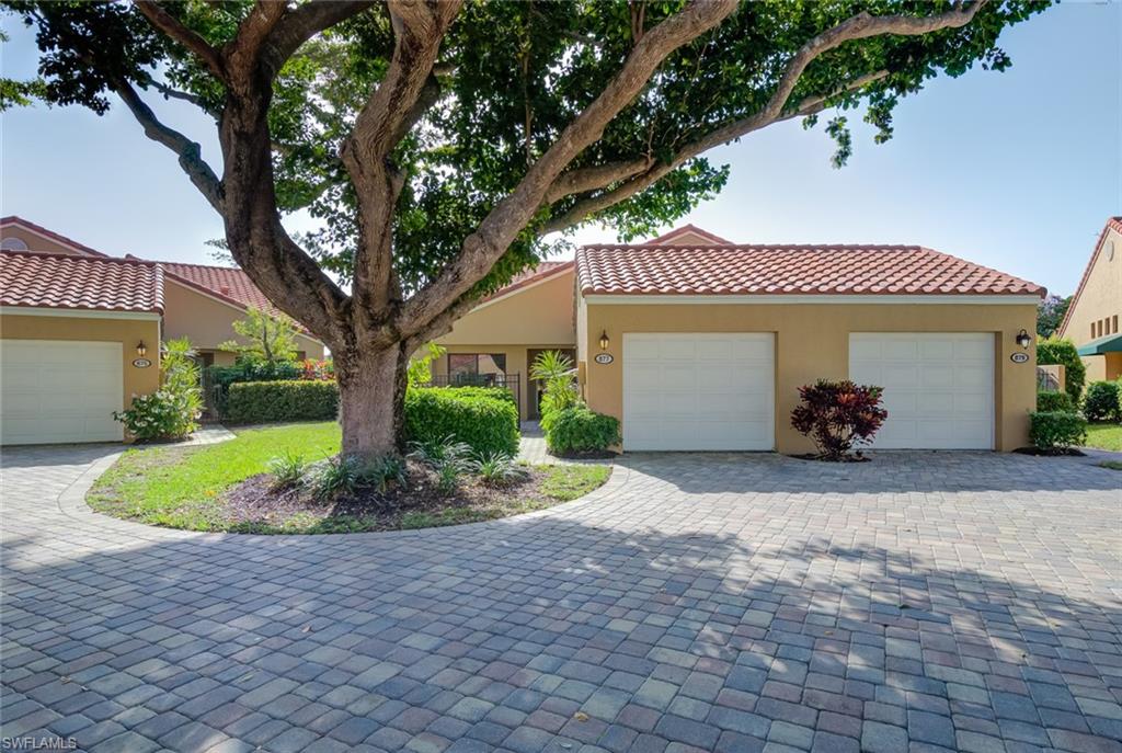 a view of a house with a yard and tree