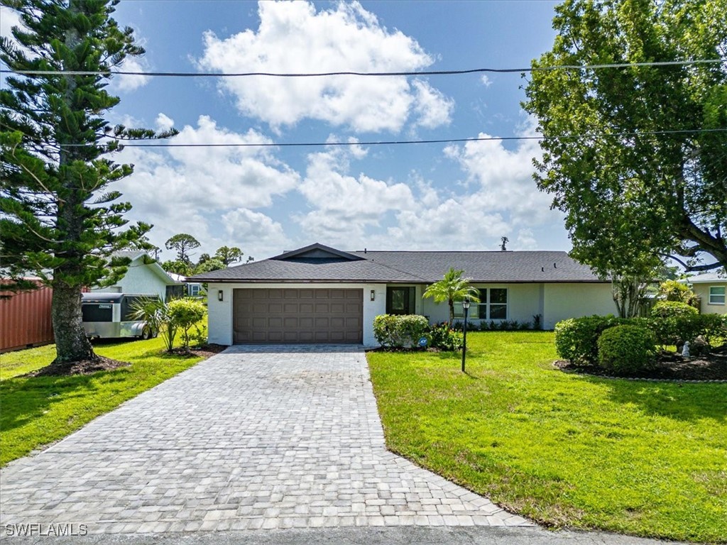 a front view of house with yard and green space