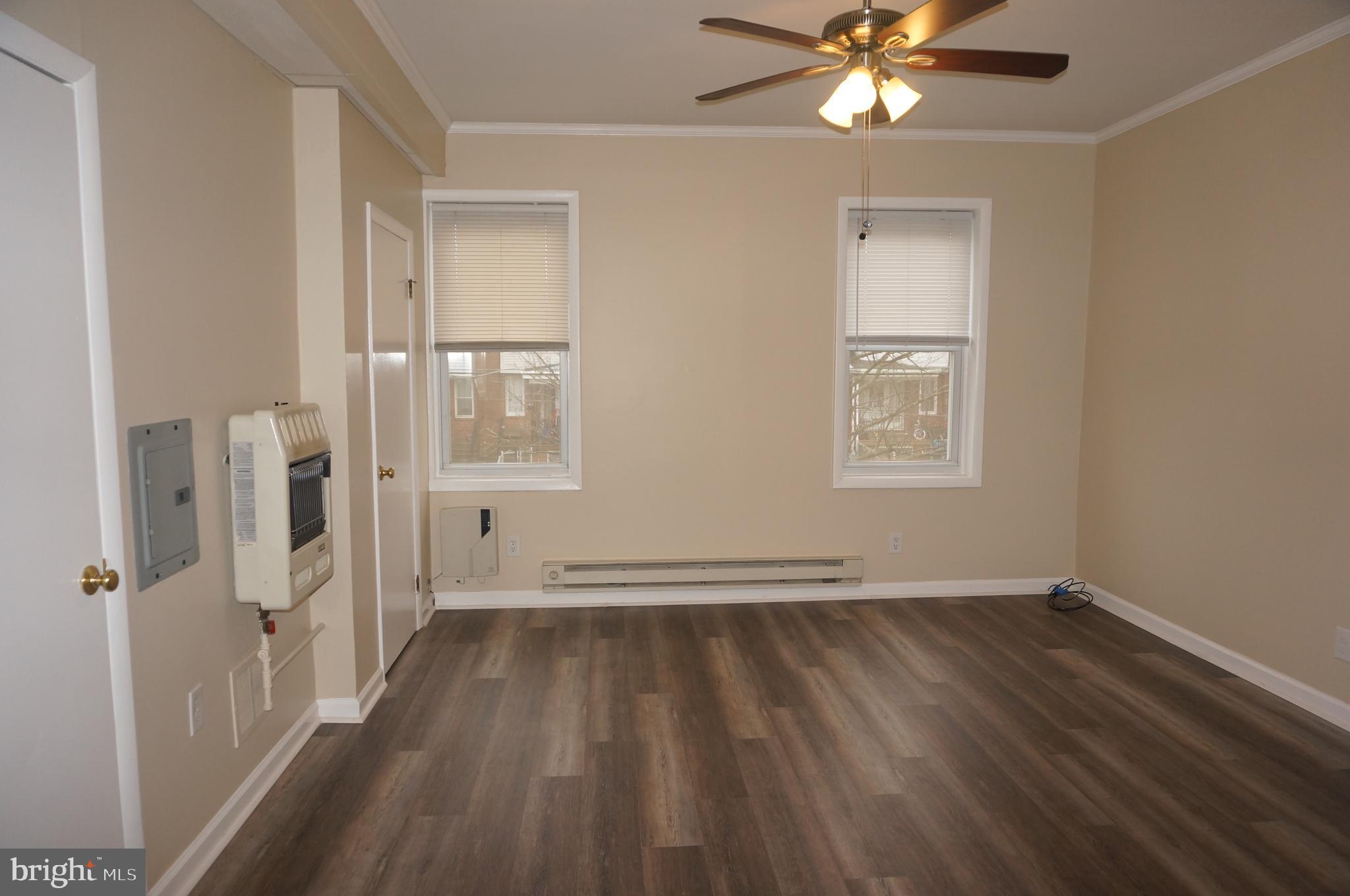 wooden floor in an empty room with a window