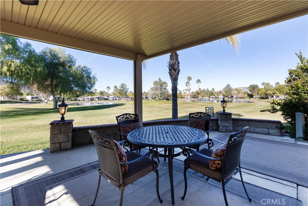 a view of a patio with swimming pool and sitting area