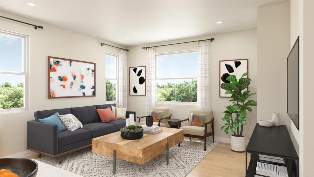 a living room with furniture and a potted plant