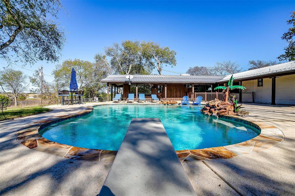 a view of a patio with swimming pool table and chairs