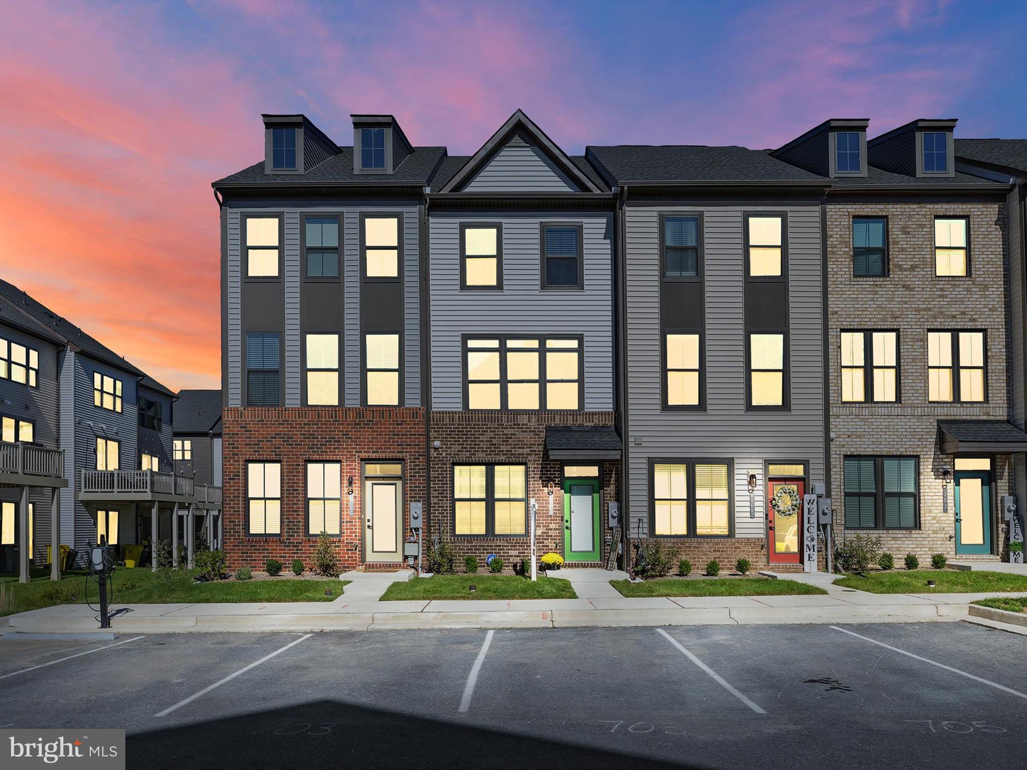 a front view of a residential apartment building with a yard