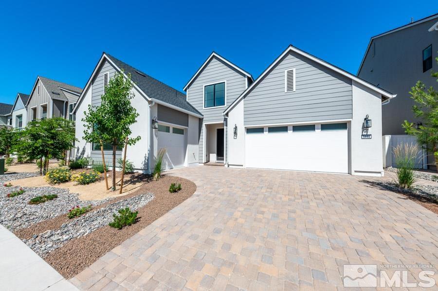 a front view of a house with yard and parking