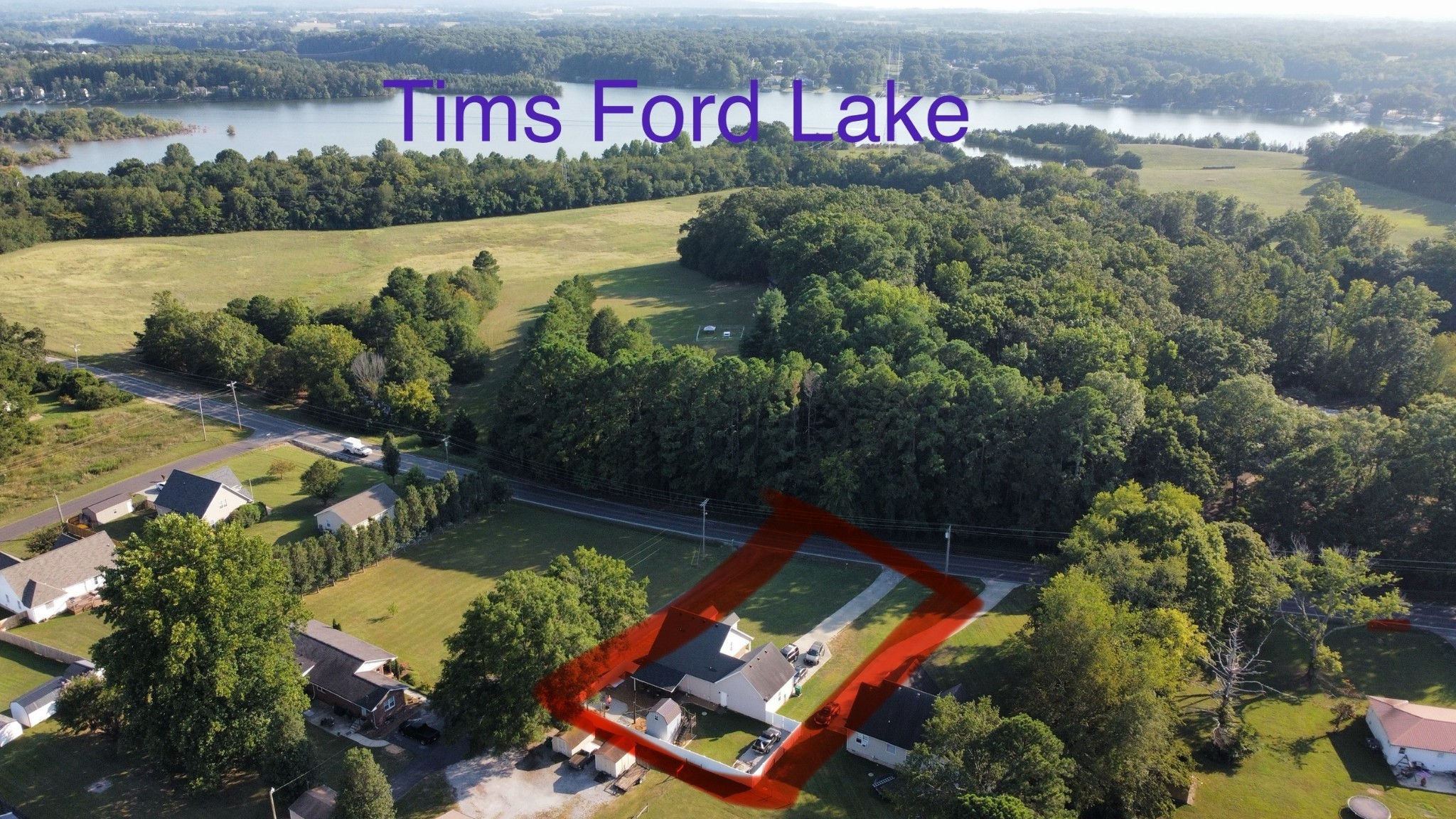 an aerial view of a house with a lake view