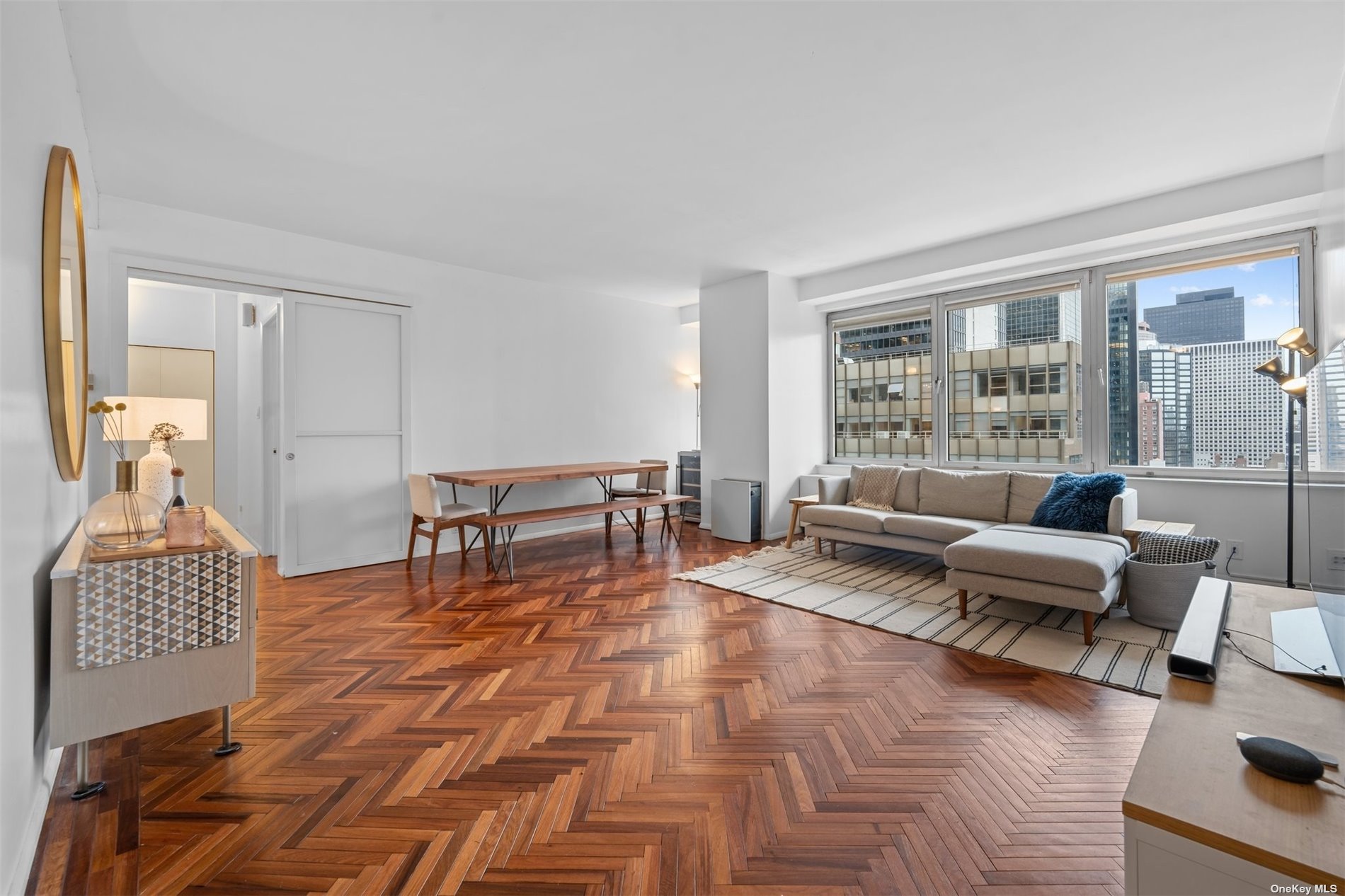 a living room with furniture and a table with wooden floor