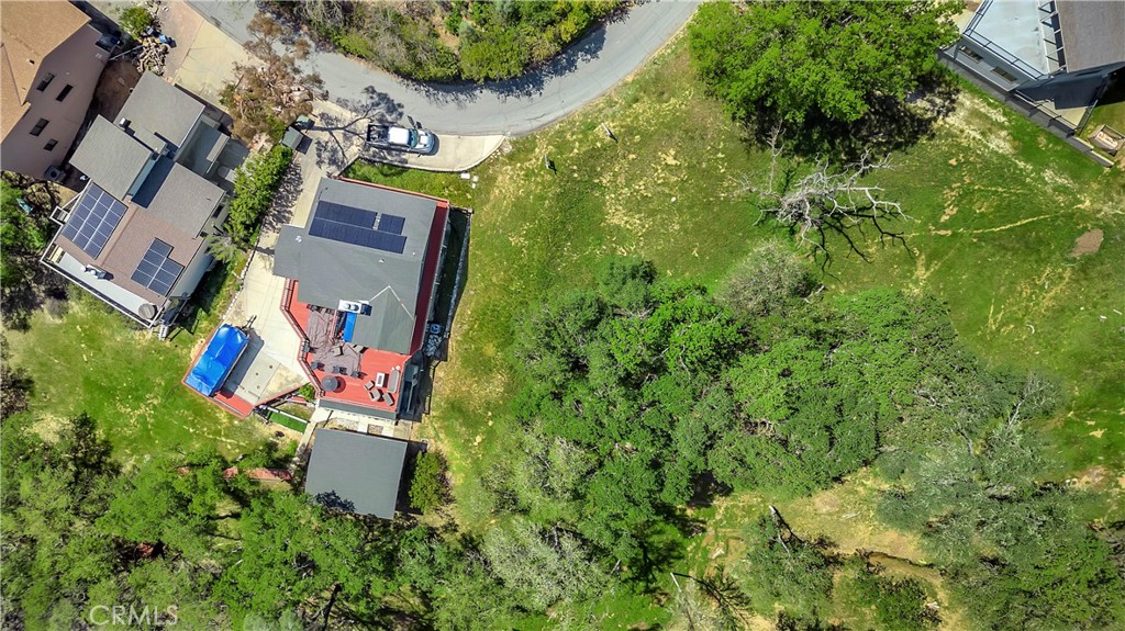 an aerial view of a house with swimming pool and garden