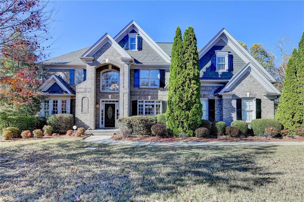 a front view of a house with a yard