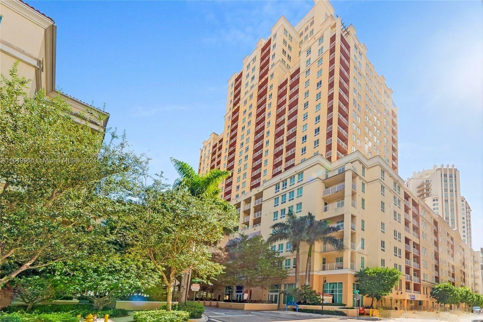 a view of a tall building next to a road