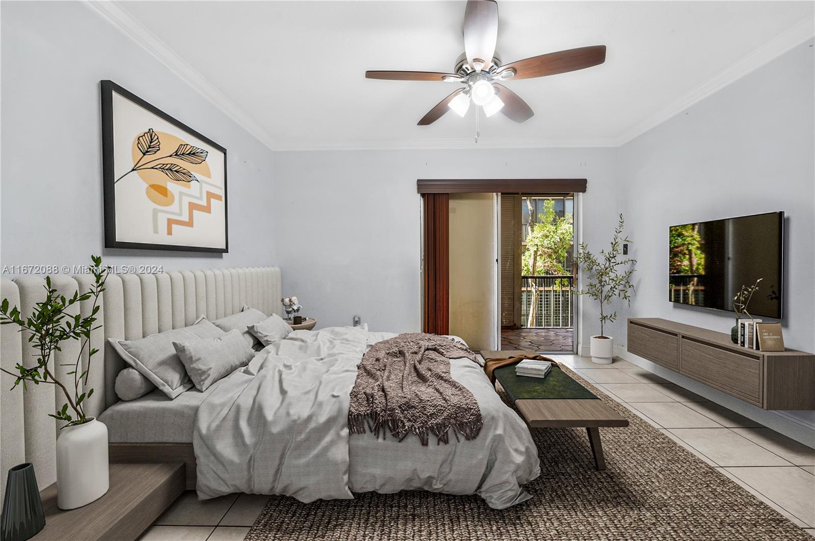 a bedroom with a bed couch and a flat tv screen