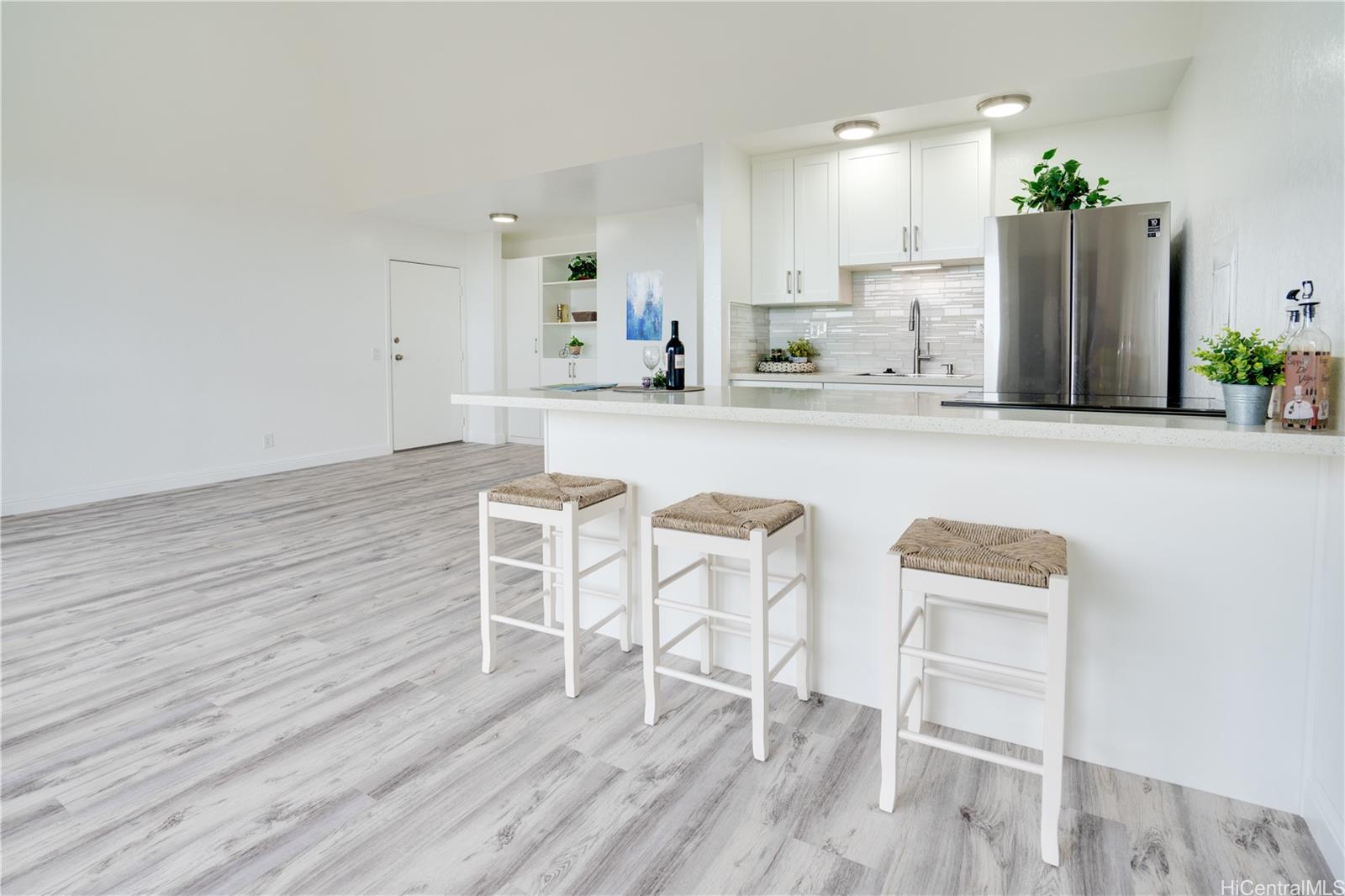 a kitchen with granite countertop white cabinets and stainless steel appliances